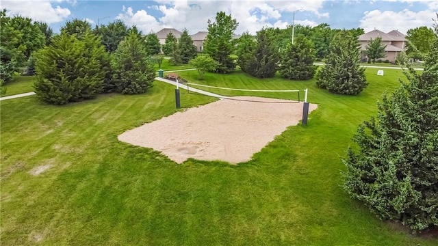 view of property's community with a yard and volleyball court