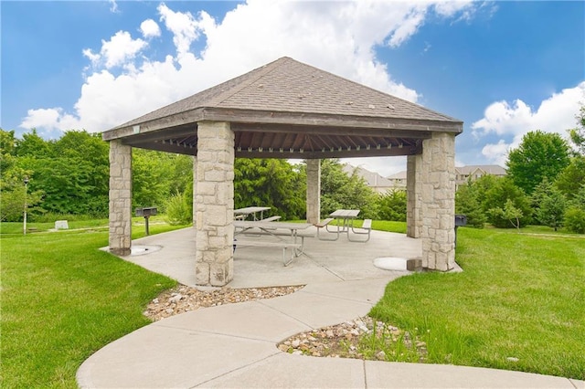 surrounding community with a patio, a gazebo, and a lawn
