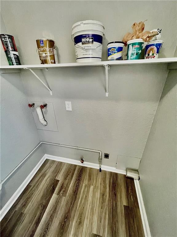 laundry area with dark hardwood / wood-style flooring