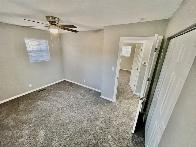 empty room featuring carpet flooring, a textured ceiling, and ceiling fan