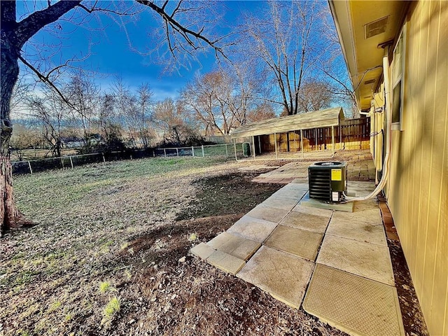 view of yard with central AC unit and a patio area