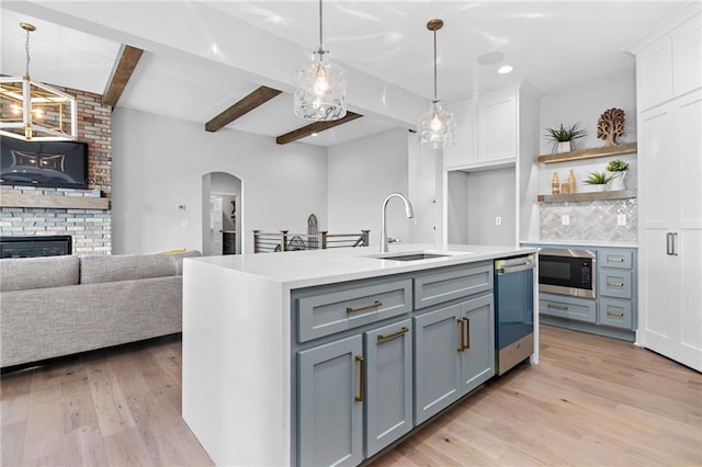 kitchen featuring backsplash, light hardwood / wood-style floors, and decorative light fixtures