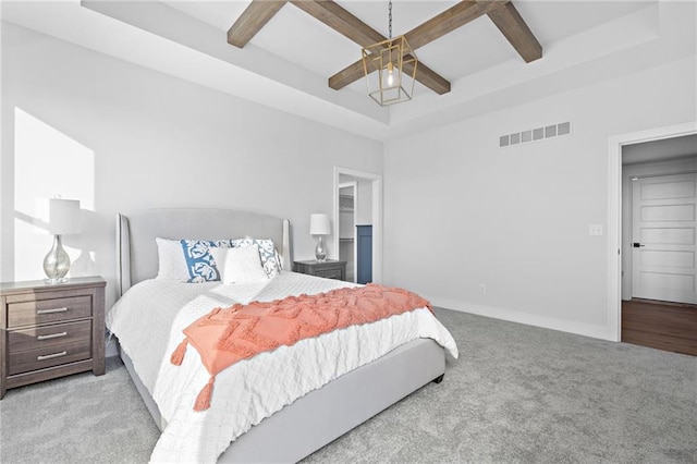 carpeted bedroom with a raised ceiling