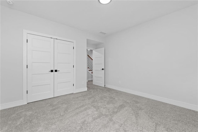 unfurnished bedroom featuring a closet and carpet flooring