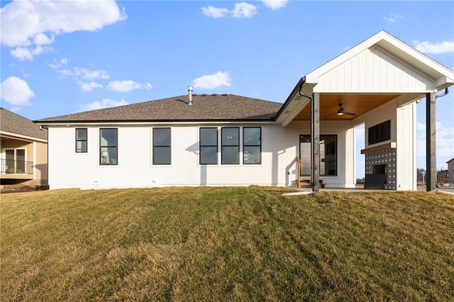 rear view of house with a yard and ceiling fan