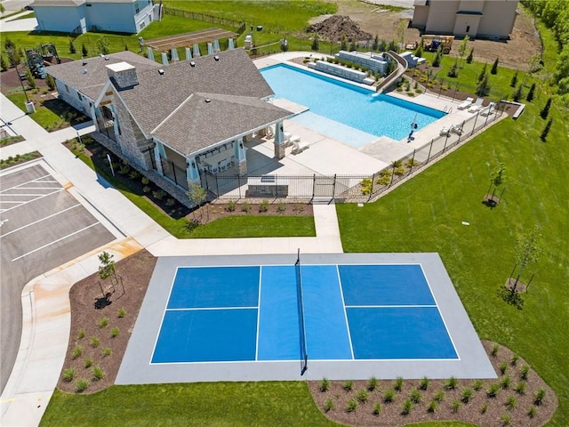 view of pool featuring a patio, a water slide, and a lawn