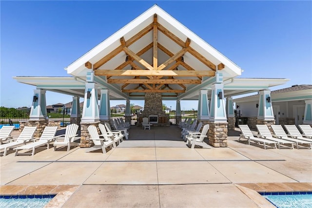 view of patio / terrace featuring a swimming pool and a gazebo