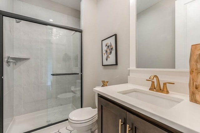 bathroom with a shower with shower door, toilet, and vanity