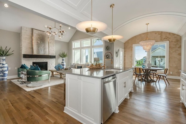 kitchen featuring decorative light fixtures, a notable chandelier, and lofted ceiling