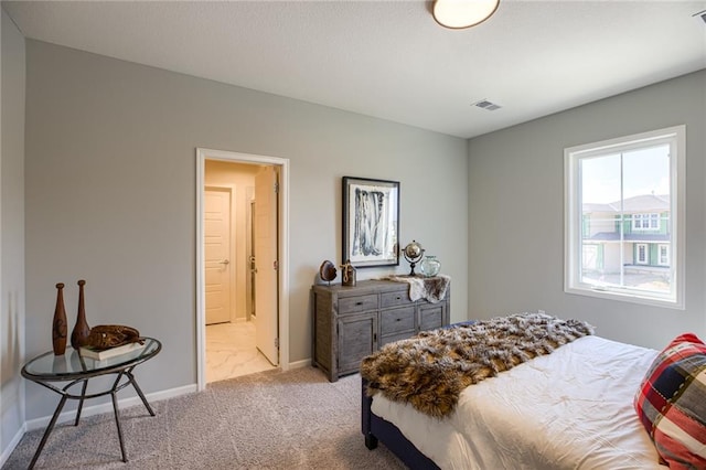 bedroom featuring light colored carpet