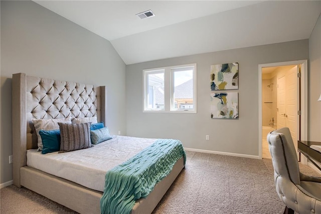 bedroom with light carpet, lofted ceiling, and connected bathroom