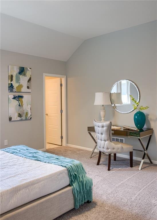 bedroom with light carpet and vaulted ceiling