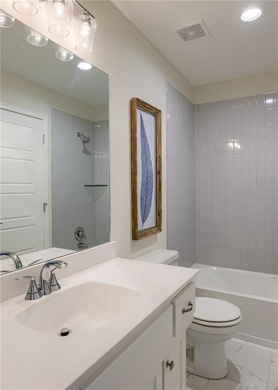 full bathroom featuring tiled shower / bath combo, toilet, tile floors, and large vanity