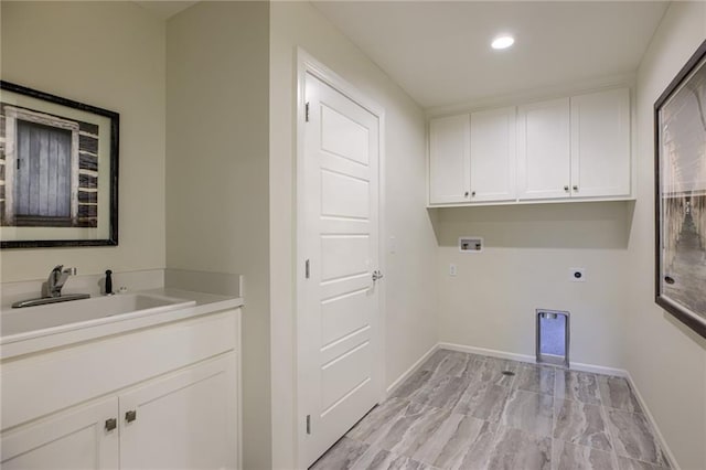 laundry area featuring electric dryer hookup, washer hookup, light tile flooring, cabinets, and sink