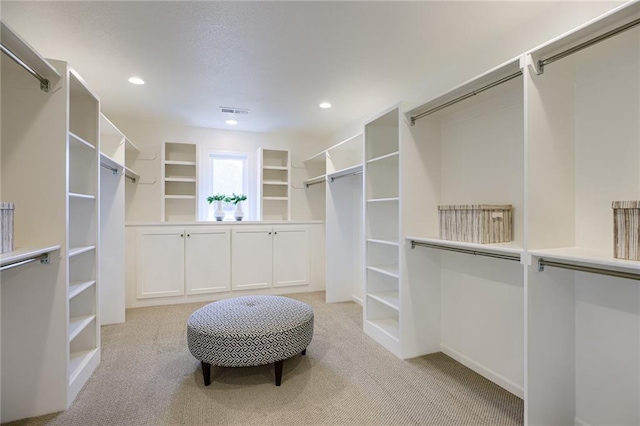 spacious closet featuring light carpet