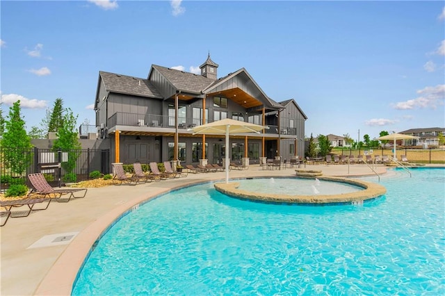 view of pool with a patio area and pool water feature