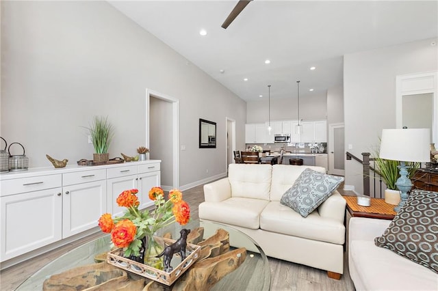 living room featuring ceiling fan and light wood-type flooring