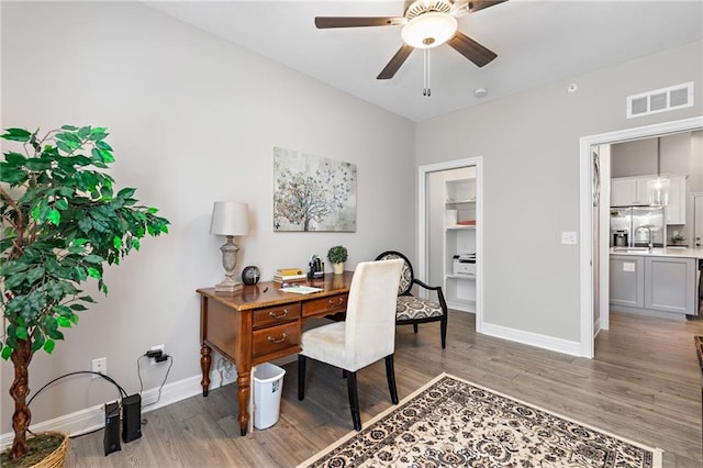 office area with light hardwood / wood-style flooring, ceiling fan, and sink