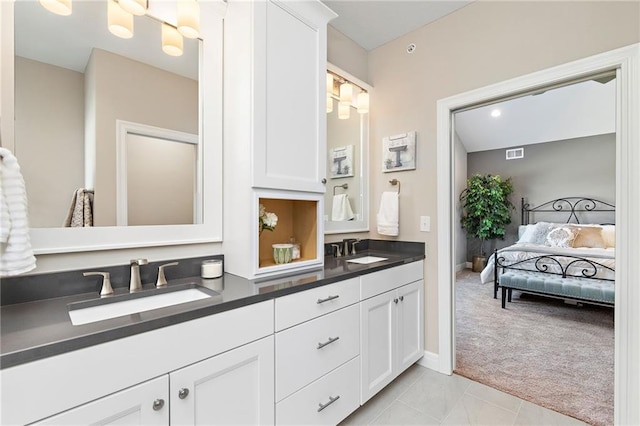 bathroom featuring tile floors and dual vanity