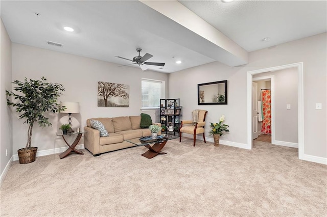 carpeted living room featuring ceiling fan