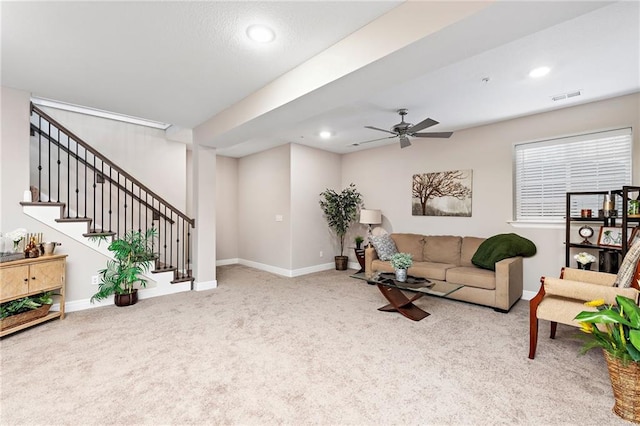 carpeted living room with ceiling fan