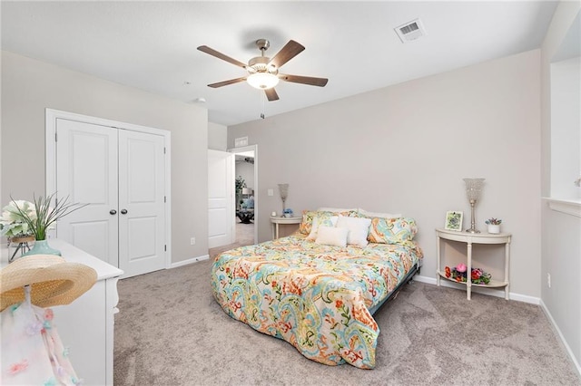 bedroom with a closet, light carpet, and ceiling fan