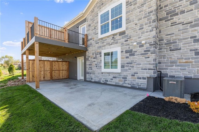 rear view of property featuring central AC and a patio area