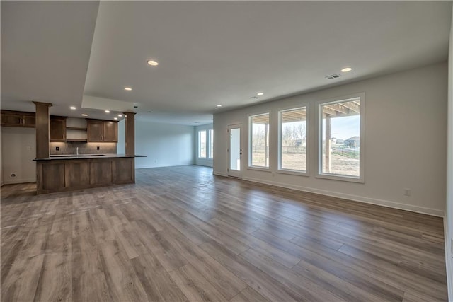 unfurnished living room with hardwood / wood-style flooring