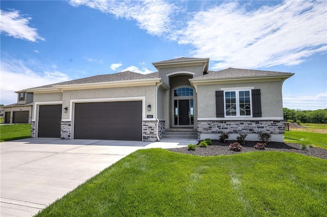 prairie-style home with a garage and a front lawn