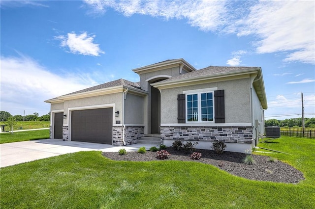 view of front of property featuring central AC, a front lawn, and a garage