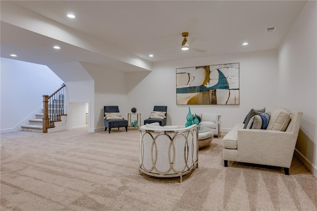 sitting room featuring ceiling fan and light colored carpet