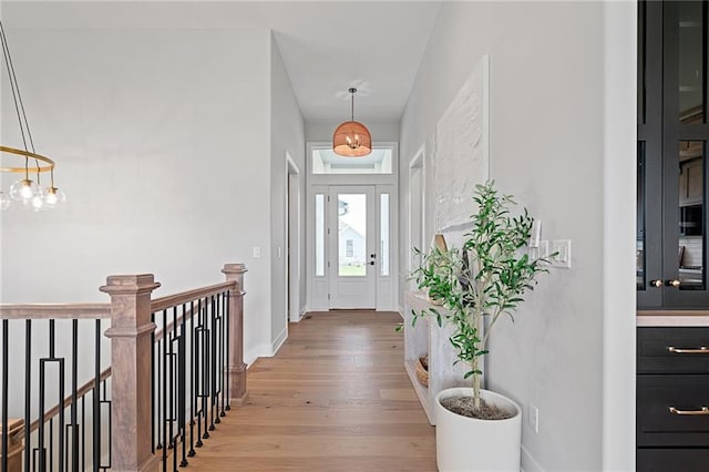 foyer featuring light hardwood / wood-style flooring and a chandelier