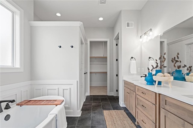 bathroom with vanity, a tub to relax in, and tile patterned floors