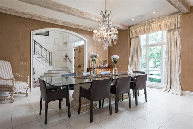 tiled dining space with an inviting chandelier and beamed ceiling