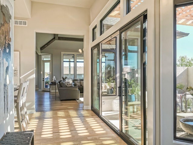 interior space featuring hardwood / wood-style floors and a towering ceiling