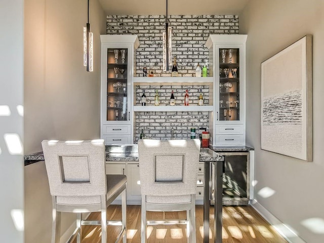 2908 NE 102nd St, Kansas City, MO 64155 - dining room featuring brick wall, beverage cooler, and light hardwood / wood-style flooring