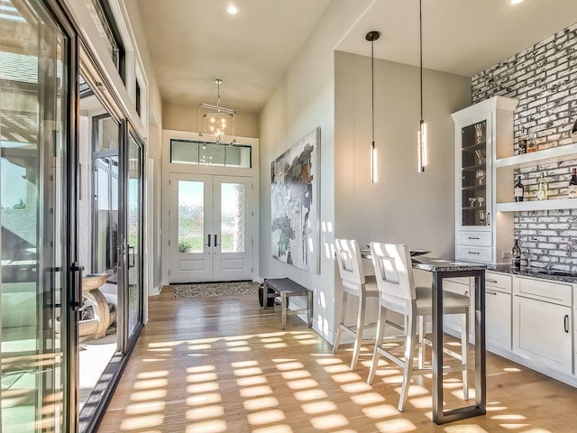 2908 NE 102nd St, Kansas City, MO 64155 - foyer entrance featuring a chandelier, light wood-type flooring, and french doors