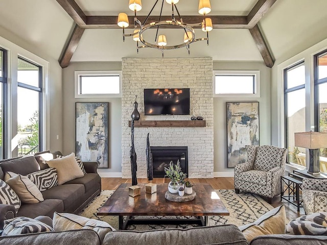 2908 NE 102nd St, Kansas City, MO 64155 - living room with a chandelier, plenty of natural light, hardwood / wood-style flooring, and a fireplace