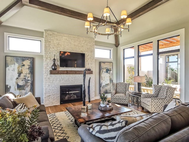 2908 NE 102nd St, Kansas City, MO 64155 - living room with an inviting chandelier, a wealth of natural light, a brick fireplace, and hardwood / wood-style flooring