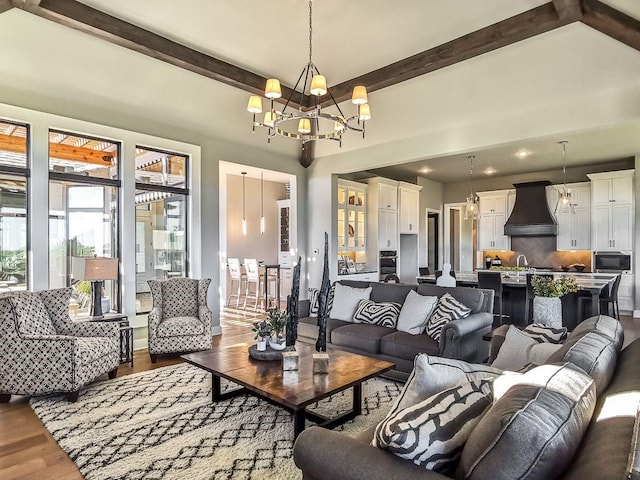2908 NE 102nd St, Kansas City, MO 64155 - living room featuring beam ceiling, a chandelier, wood-type flooring, and sink