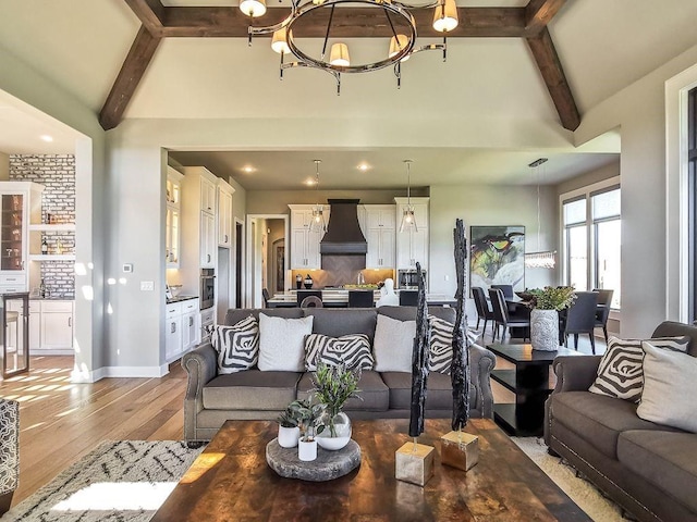 2908 NE 102nd St, Kansas City, MO 64155 - living room with an inviting chandelier, vaulted ceiling with beams, and light hardwood / wood-style flooring