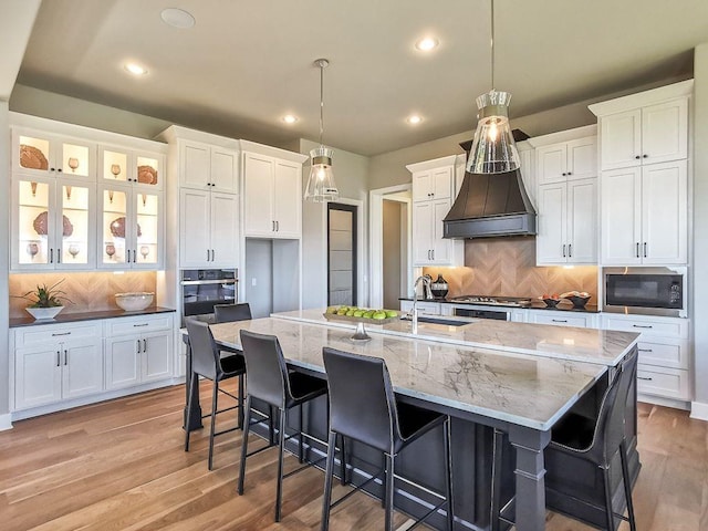 2908 NE 102nd St, Kansas City, MO 64155 - kitchen featuring backsplash, custom exhaust hood, stainless steel appliances, and white cabinetry