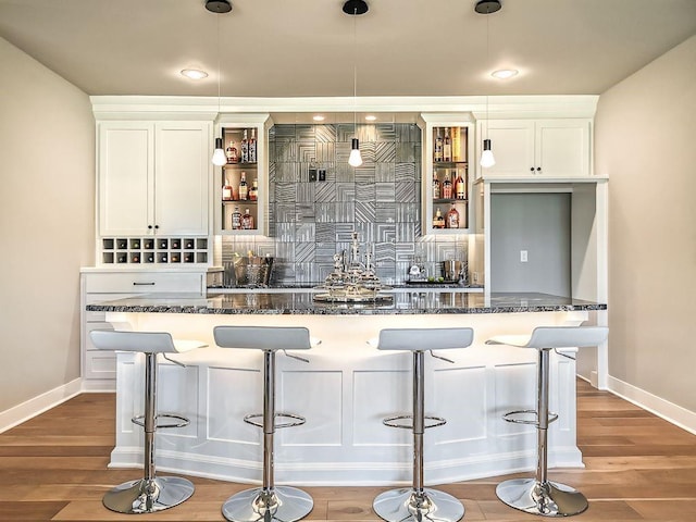 2908 NE 102nd St, Kansas City, MO 64155 - bar with white cabinets, pendant lighting, and hardwood / wood-style flooring
