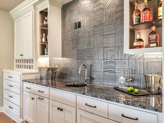 2908 NE 102nd St, Kansas City, MO 64155 - bar with sink, backsplash, white cabinetry, and dark stone counters