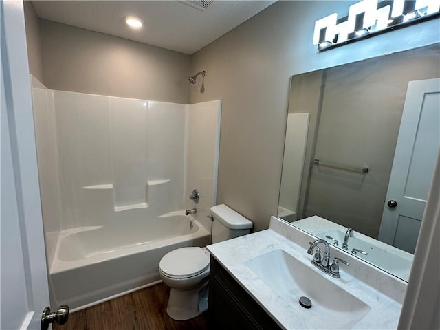 full bathroom featuring  shower combination, toilet, vanity, and wood-type flooring