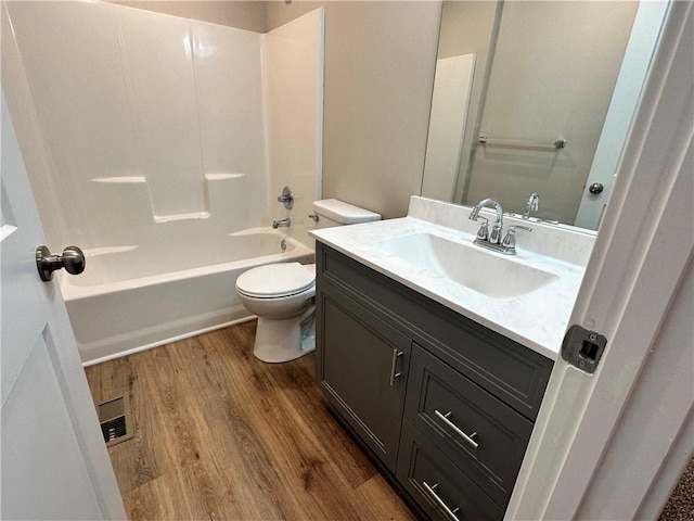 full bathroom featuring bathtub / shower combination, toilet, vanity, and hardwood / wood-style flooring