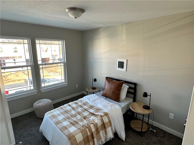 carpeted bedroom featuring a textured ceiling