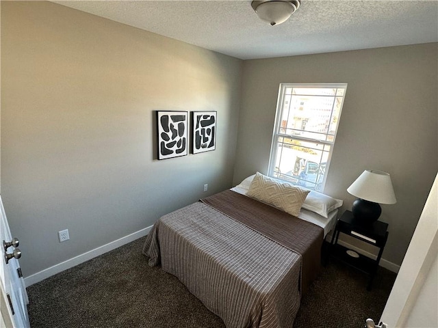 carpeted bedroom featuring a textured ceiling