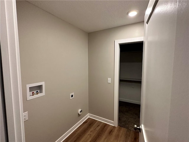 clothes washing area featuring electric dryer hookup, a textured ceiling, dark wood-type flooring, and hookup for a washing machine