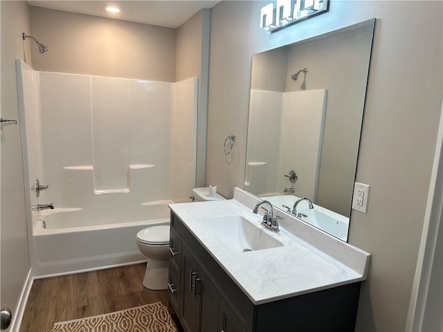 full bathroom featuring oversized vanity, shower / bathing tub combination, toilet, and hardwood / wood-style floors